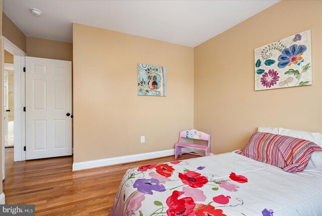 bedroom with hardwood / wood-style flooring