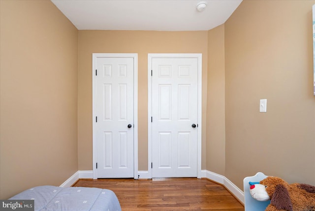 bedroom with wood-type flooring