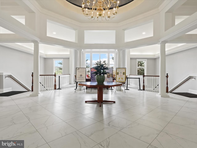 interior space featuring a notable chandelier, plenty of natural light, and a tray ceiling