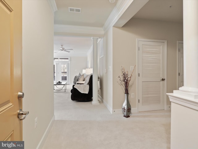 corridor with light carpet, crown molding, and ornate columns