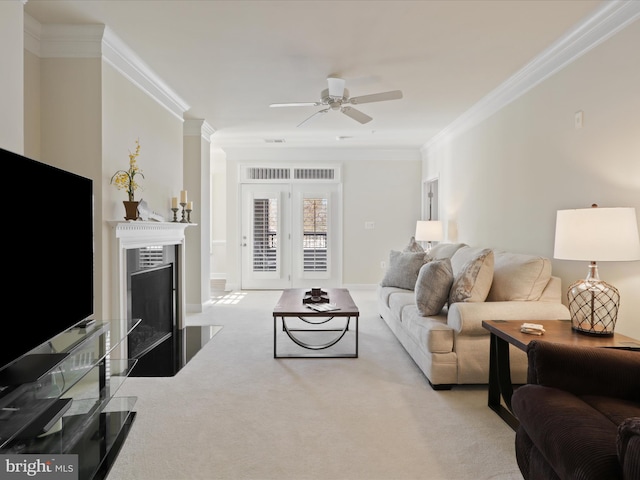 carpeted living room featuring ceiling fan and crown molding