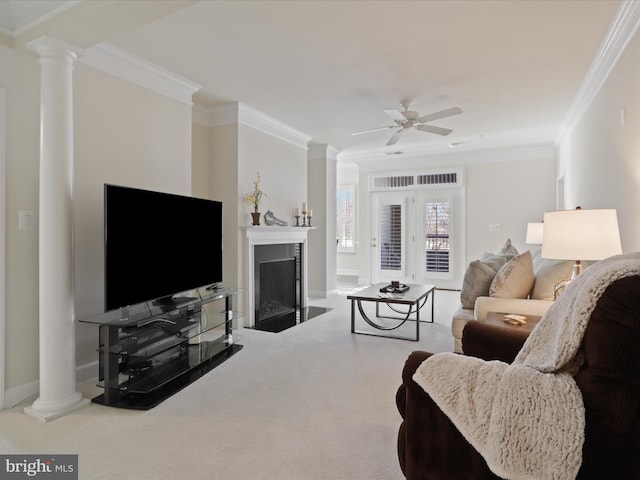 living room with ceiling fan, ornamental molding, and carpet floors