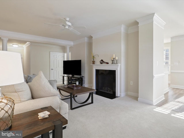 carpeted living room with ceiling fan and ornamental molding