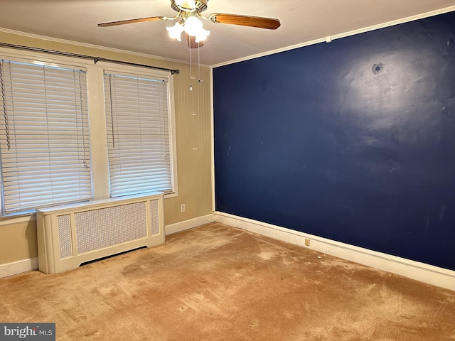 unfurnished room featuring radiator, crown molding, ceiling fan, and light colored carpet