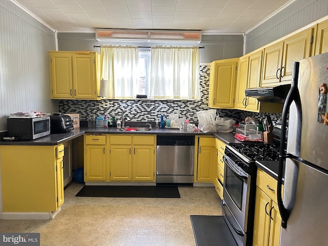 kitchen with backsplash, crown molding, sink, and appliances with stainless steel finishes