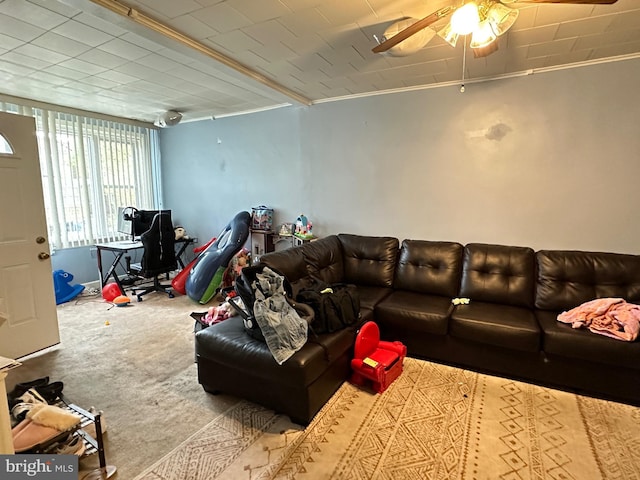 living room with carpet, ceiling fan, and ornamental molding