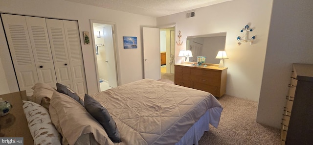 bedroom with light colored carpet, a closet, and a textured ceiling