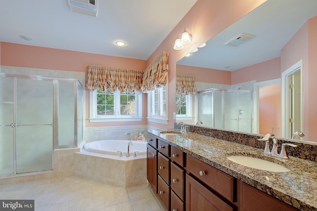 bathroom with tile patterned floors, shower with separate bathtub, and vanity