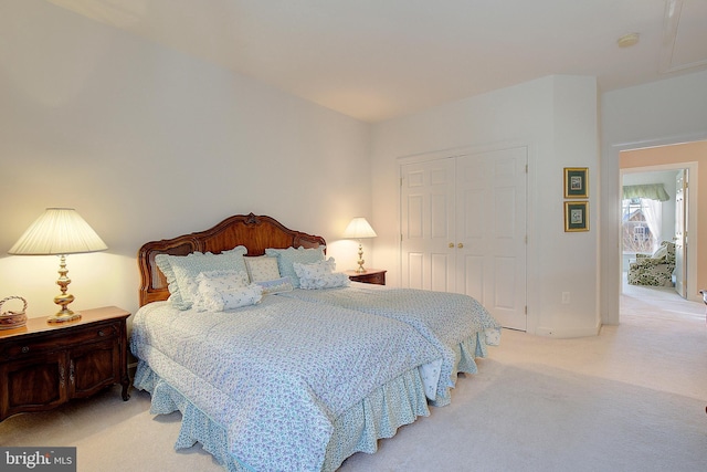 bedroom with light colored carpet and a closet