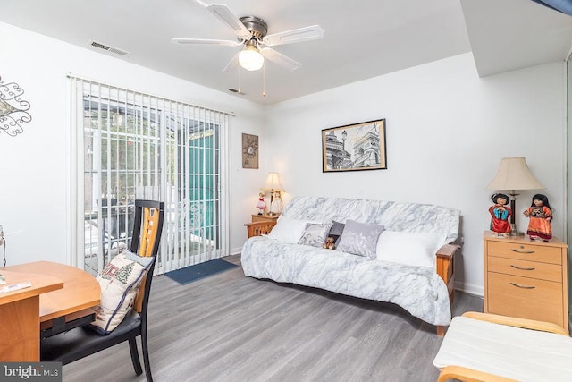 living room featuring ceiling fan and wood-type flooring