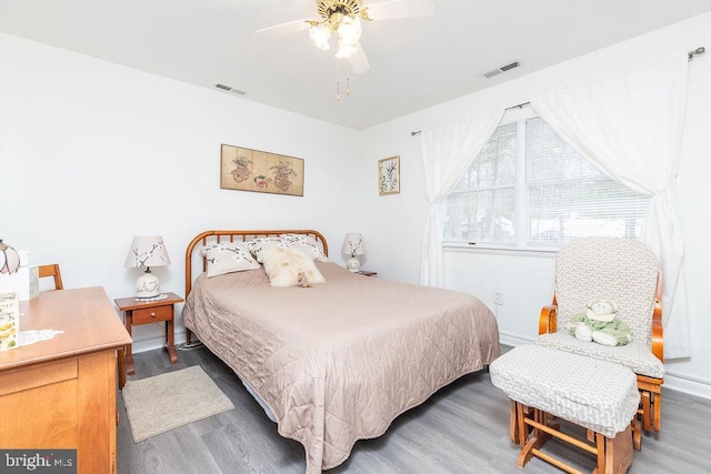 bedroom with ceiling fan and wood-type flooring