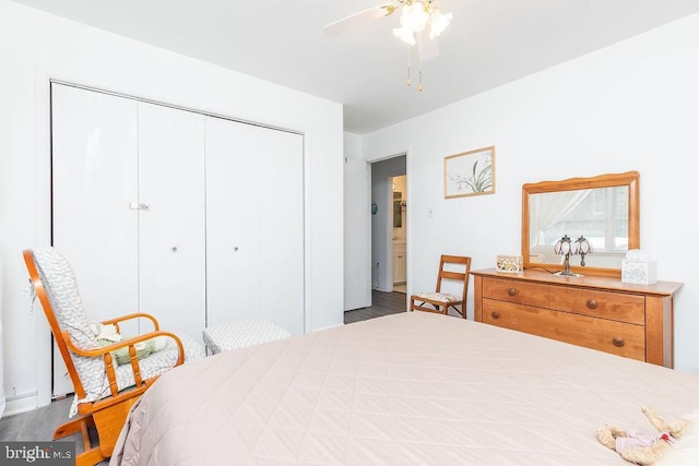 bedroom with ceiling fan, wood-type flooring, and a closet