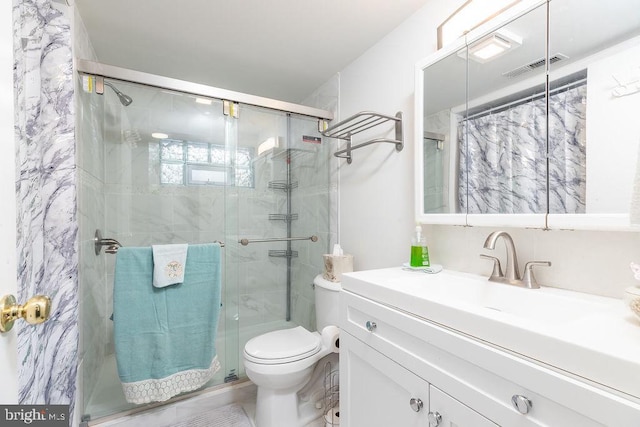 bathroom with walk in shower, vanity, and toilet