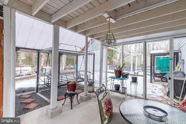 sunroom / solarium with a wealth of natural light and beam ceiling