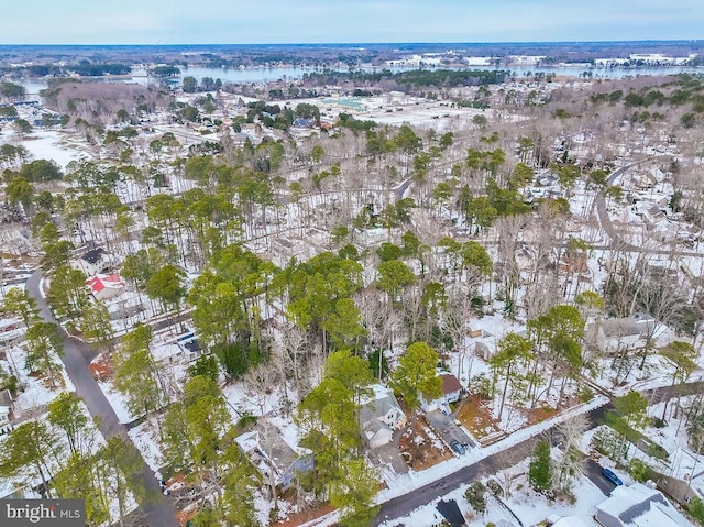 snowy aerial view featuring a water view