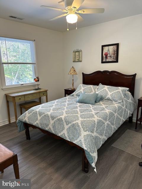 bedroom featuring ceiling fan and dark hardwood / wood-style floors