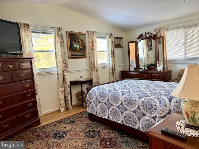 bedroom with wood-type flooring and lofted ceiling