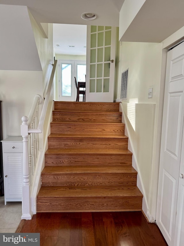 staircase with hardwood / wood-style flooring