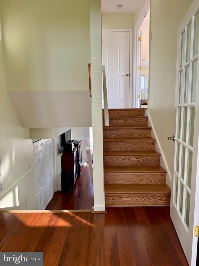 stairway featuring hardwood / wood-style floors