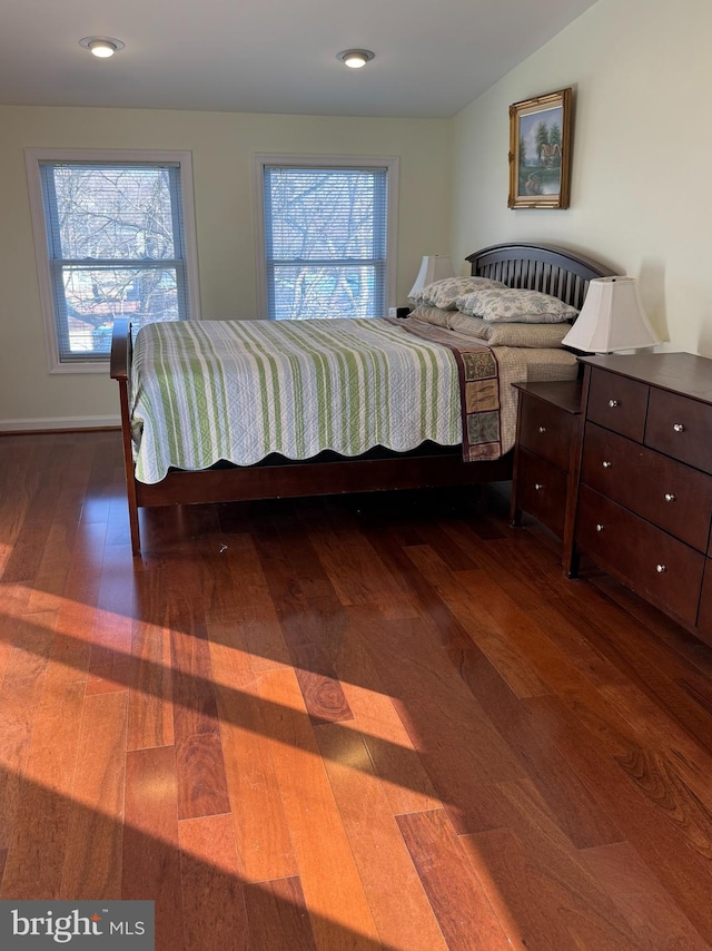 bedroom with dark wood-type flooring and vaulted ceiling