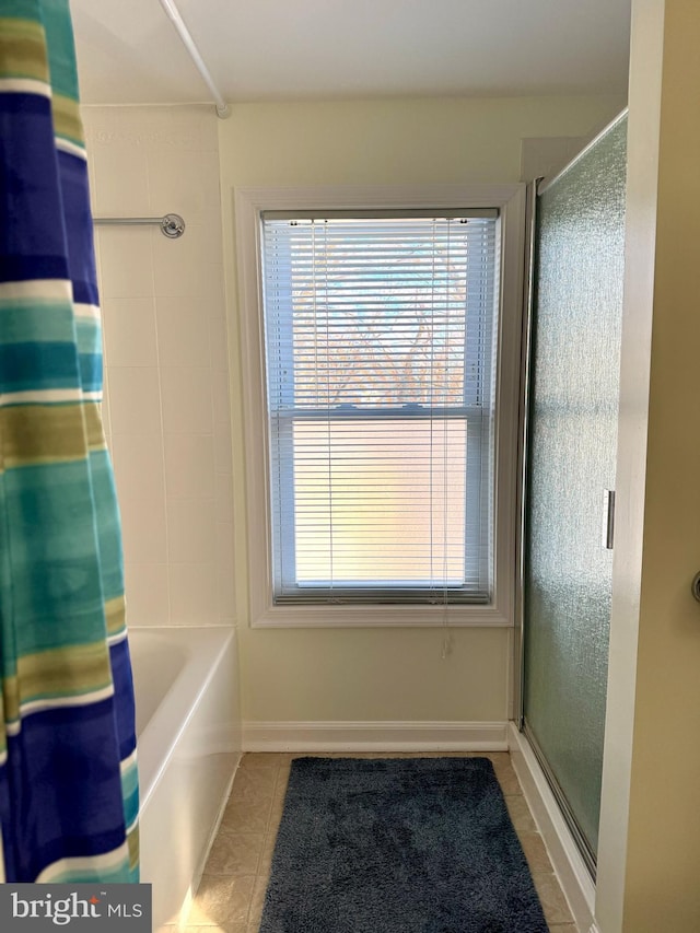 bathroom with tile patterned flooring and a shower