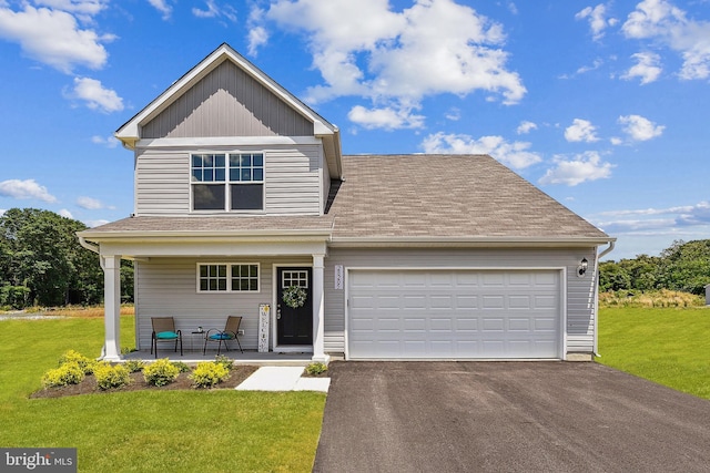 craftsman-style home featuring a front yard, a porch, and a garage