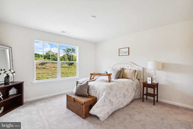 bedroom featuring light carpet