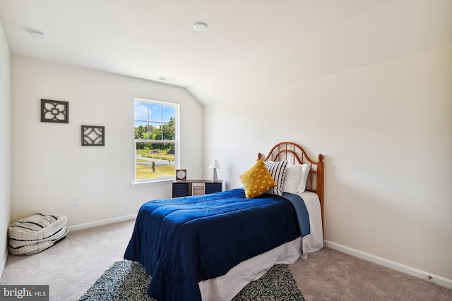 carpeted bedroom with lofted ceiling