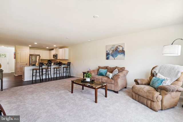 living room featuring light carpet