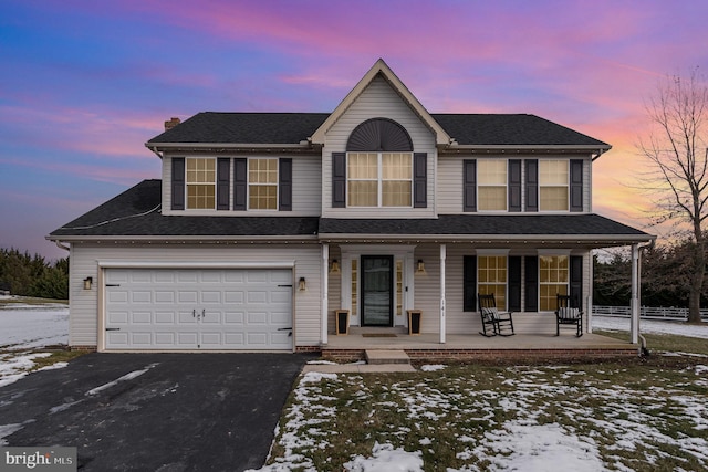 view of front of house featuring covered porch and a garage