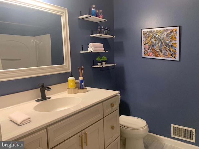 bathroom featuring vanity and toilet