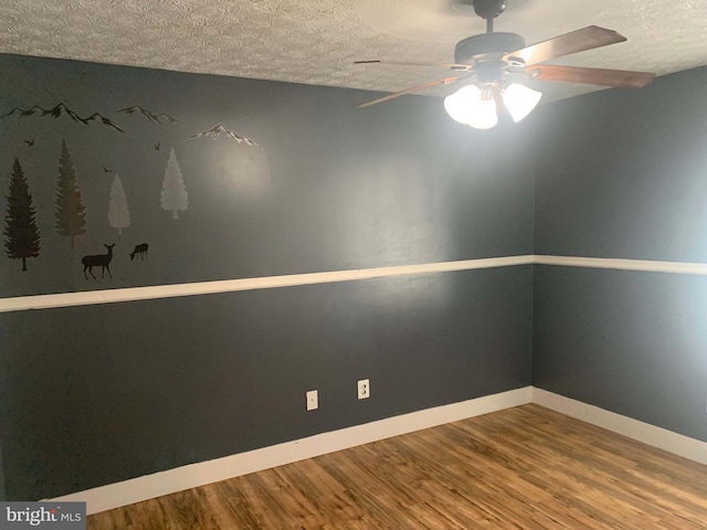 empty room featuring a textured ceiling, ceiling fan, and wood-type flooring