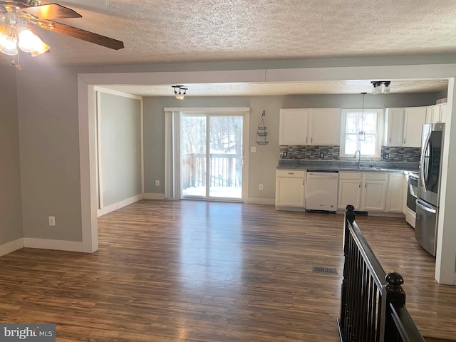 kitchen featuring decorative backsplash, white cabinetry, white dishwasher, ceiling fan, and sink