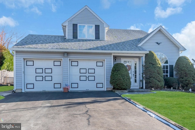 view of front of property featuring a front lawn and a garage