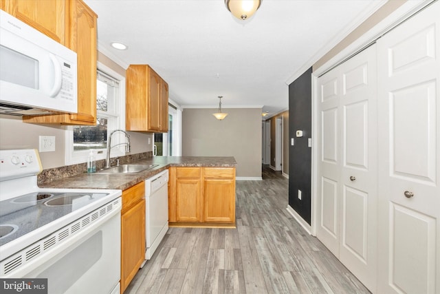 kitchen with pendant lighting, white appliances, sink, ornamental molding, and kitchen peninsula