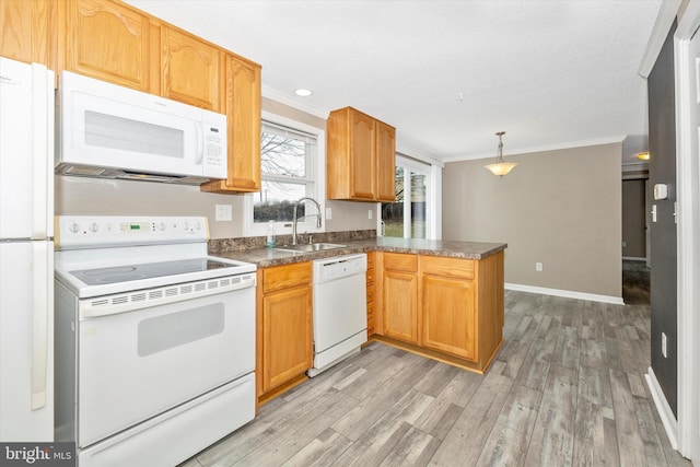 kitchen featuring pendant lighting, white appliances, sink, ornamental molding, and kitchen peninsula