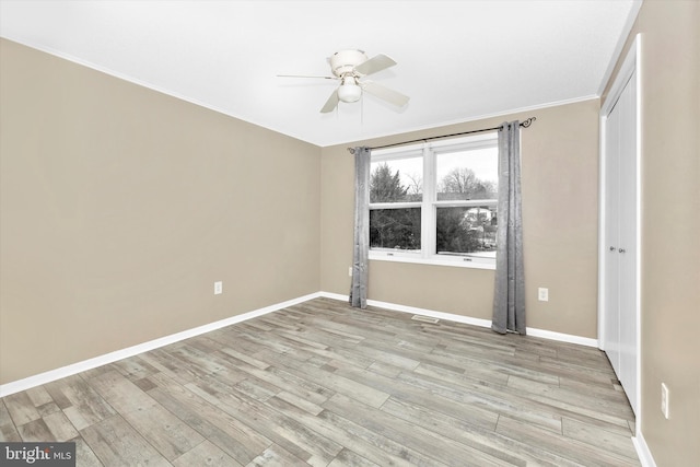 unfurnished bedroom with ceiling fan and light wood-type flooring