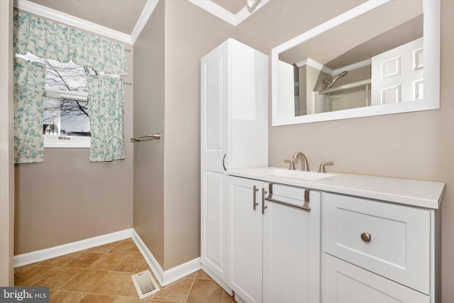 bathroom featuring tile patterned floors, vanity, and ornamental molding