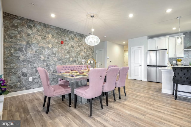 dining space with light wood-type flooring