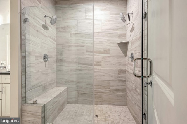 bathroom featuring a shower with shower door