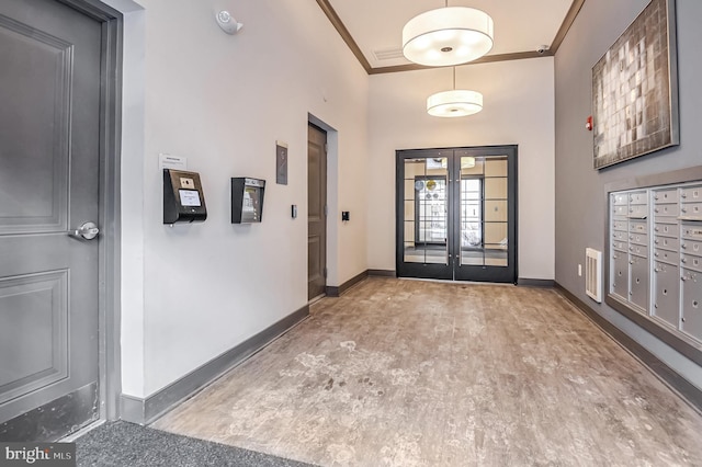 doorway to outside featuring french doors, ornamental molding, mail boxes, and a high ceiling