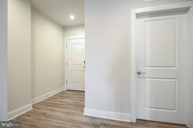 corridor with light hardwood / wood-style flooring