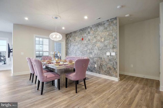 dining room featuring an inviting chandelier and light hardwood / wood-style floors