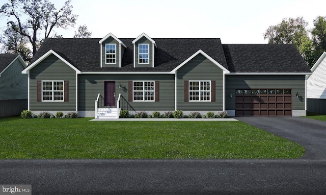 view of front of property with a garage and a front lawn