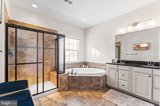 bathroom featuring plus walk in shower and vanity