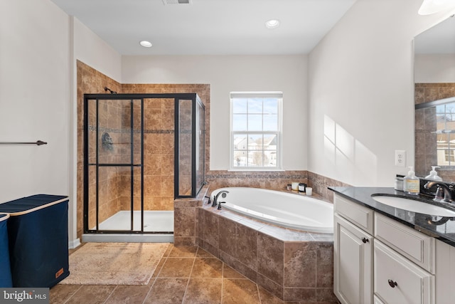 bathroom featuring tile patterned floors, vanity, and shower with separate bathtub