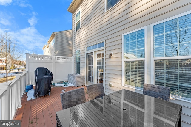 wooden deck with a grill