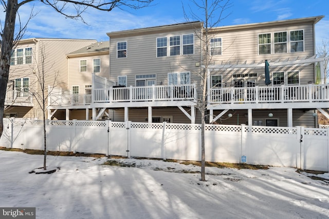 view of snow covered back of property