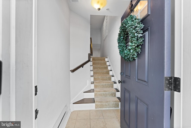 entrance foyer with a baseboard heating unit and light tile patterned floors