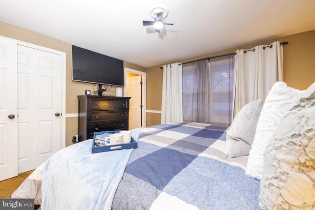 bedroom featuring ceiling fan and a closet